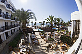 Seating On A Patio With Palm Trees And A View Of The Mediterranean; Paphos, Cyprus