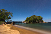 Beach And Small Bridge Going From Mumbo Island To Small Island For Tourist's Accommodation Under A Starry Sky, Lake Malawi; Malawi