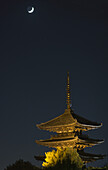 Night View Of A Japanese Pagoda With Moon Crescent; Kyoto, Japan