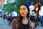 Eine junge Frau beim Einkaufen auf der Straße, Kowloon; Hongkong, China.