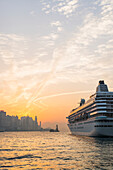 Cruise Ship In The Harbour At Sunset, Kowloon; Hong Kong, China