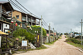 Dirt Road Lined With Residential Buildings; Punta Del Diablo, Uruguay