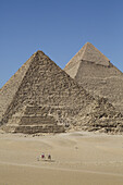 Camels With Tourist And Guide, Queen's Pyramid And Pyramid Of Chephren (Background), The Giza Pyramids; Giza, Egypt