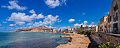 Trapani skyline with old, stone buildings and sea wall along the shoreline; Trapani, Sicily, Italy