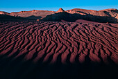 Wind and water sculpted desert in the Valle de la Luna. Shadows fall in the Valley of the Moon in the Atacama Desert, the driest place on earth where the elements have left an array of oddly shaped polychrome forms in the desolate, eroded desert landscape. The region sometimes goes without recorded precipitation for more than a century; Valle de la Luna, Atacama Desert, Chile