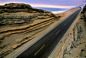 The Pan American Highway is an empty, lonely, desolate road as it runs along Peru's Pacific Desert Coast along the ocean for hundreds of miles; Near Chala, Peru