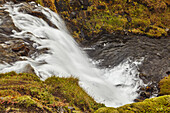 Moss covered rock and the rugged beauty of Hafrafell waterfall in mountains near Stykkisholmur, Snaefellsnes peninsula in Western Iceland; Iceland