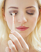 Close up of Young Woman Applying Eye Shadow