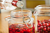Adding Vodka to Cherries in Mason Jar