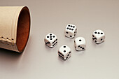 Still life five white dice and leather cup on white background