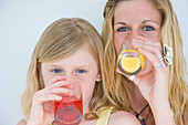 Woman and Young Girl Drinking Juice