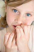 Young Girl with Fingers in Front of Mouth
