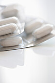 Pills in Blister Packs on white table
