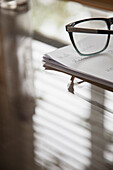 Eyeglasses and Paperwork on Desk