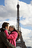 Couple kissing in front of the Eiffel Tower