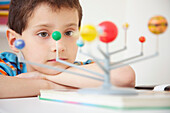 Boy Inspecting Solar System Model