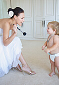 Bride Laughing and Playing with Baby Boy