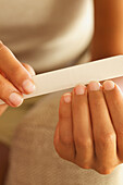 Woman Filing Fingernails, Close-up View