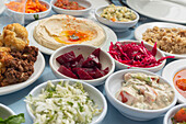 Still life close up Israeli meze appetizers in bowls on table