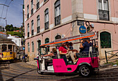 Trams and tourist buggies in the Alfama old town area of Lisbon, Portugal, Europe