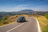 Blick auf eine kurvenreiche Straße bei Torraccia und San Marino im Hintergrund, San Marino, Italien, Europa