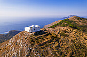 Aerial view of the white Chapel of San Costanzo on top of a mountain surrounding the sea of Amalfi coast, Punta Campanella, Massa Lubrense municipality, Naples province, Campania region, Italy, Europe