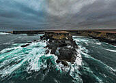 Aerial of the wild coastline with basalt pools on the Atlantic coastline, Dombe Grande, Namibre, Angola, Africa