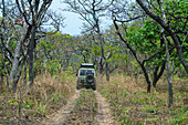 Jeep driving through the Cangandala National Park, Malanje, Angola, Africa
