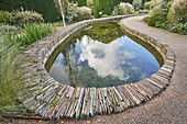 A formal garden scene, with pond, in Devon, England, United Kingdom, Europe