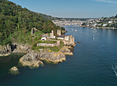 An aerial view of the historic 16th century Dartmouth Castle, in the mouth of the River Dart, with a view of Dartmouth in the background, on the south coast of Devon, England, United Kingdom, Europe