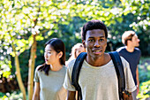 Young adult man wearing backpack during hiking with friends