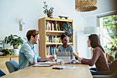 Group of coworkers brainstorming while gathered at office