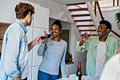 Group of friends toasting with wineglasses while hanging indoors