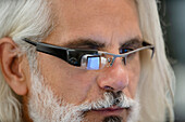 Close-up portrait of man's face wearing smart glasses
