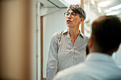 Female business manager talking with colleague at office