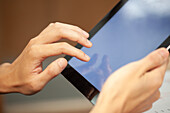 Close-up of unrecognizable person hands using digital tablet