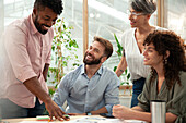 Group of coworkers brainstorming during meeting at office