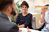Cheerful adult woman listening carefully during real estate meeting