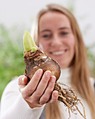 Young lady with amaryllis bulb
