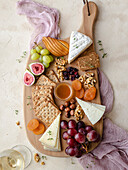 Autumn cheese platter with a cup of white wine