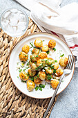 Top roasted spring potato vegetables with herbs, served in a bowl for lunch