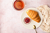 Tea and croissant over table