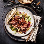 Salad with Roast Beef and vegetables on dark background
