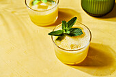 Pineapple mint G&Ts with spout on yellow background with shadow