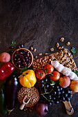 Mediterranean diet with raw ingredients such as fruits, vegetables, legumes and nuts with negative copy space