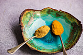 Vintage spoons with powdery spices of ginger and turmeric