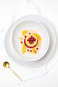 Tangerine gazpacho dessert in a white bowl