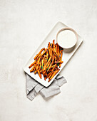 Baked sweet potato fries on a white plate