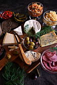 Healthy probiotic cheese platter served with kimchi, dark dye sourdough bread, and fermented vegetables. Close up.