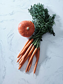 Top view with autumn orange produce. Carrots, pumpkin, butternut squash